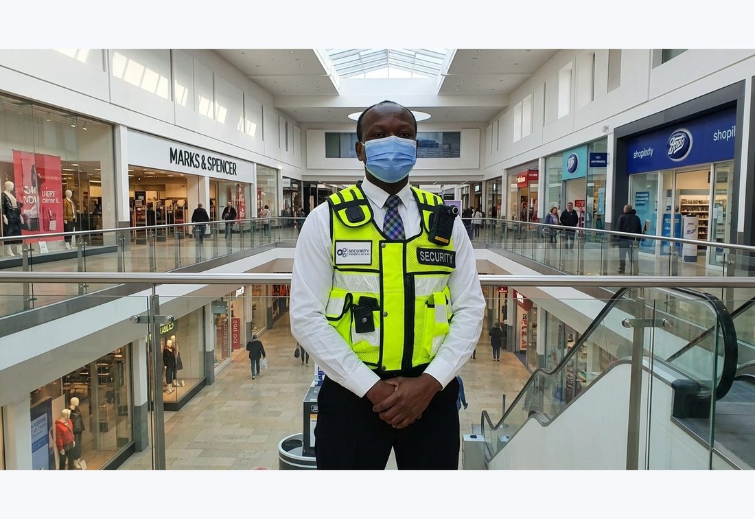 Security Projects UK retail security officer at a shopping centre with Marks & Spencer and Boots behind